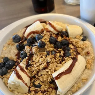 a bowl of oatmeal with bananas and blueberries