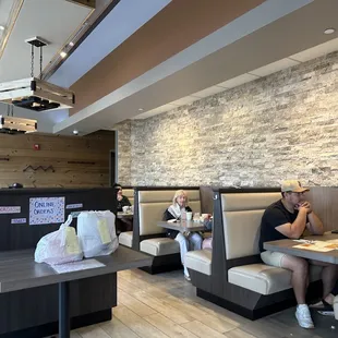 two people sitting at booths in a restaurant
