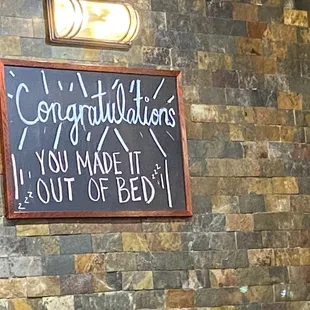 a sign on a brick wall