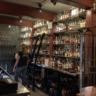 a woman standing at the bar