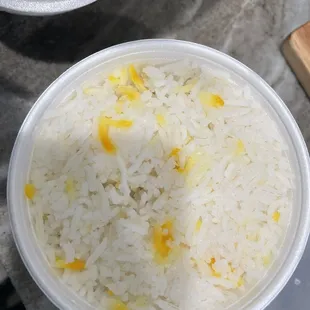 a bowl of rice and a cutting board