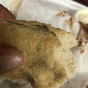 a hand holding a piece of bread