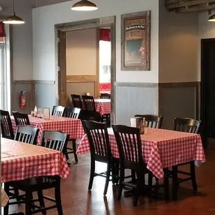 tables and chairs with red and white checkered tablecloths