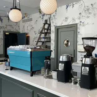 a blue coffee maker and coffee grinder