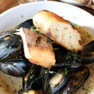 a plate of mussels and bread