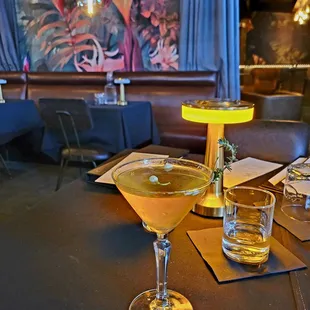 Tasty Jasmine Martini with Elderflower pods floating on the surface, and a sprig of thyme on the rim