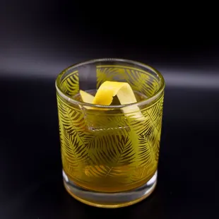 a glass with a lemon peel in it