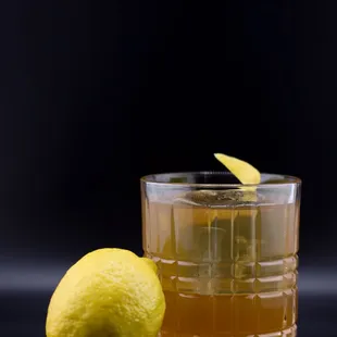 a glass of lemonade and a lemon