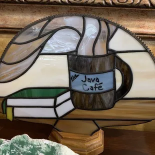 a stained glass fan with a cup of coffee