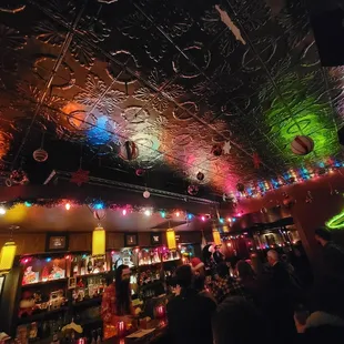 a crowded bar with disco lights