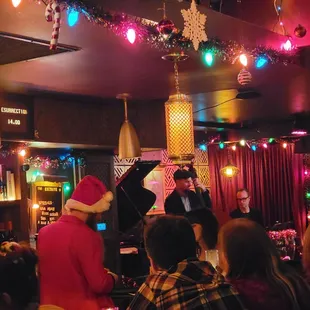 a man in a santa hat playing the piano