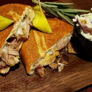 Jerk Joint Cuban has Turkey Ham Jerk Chicken,Cheddar &amp; mozzarella cheese w/ spicy Mayo and dill pickle spear w/Mcmannis Sauce.