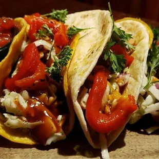Tacos 4 Jerks are 3 flour Tortillas w/ Cheddar Cheese Jerk Chicken Cilantro lime Coleslaw Roasted Red Peppers drizzled in McMannis sauce