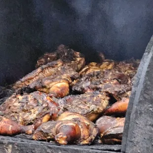 The Jerk Chicken being cooked outside