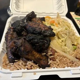 Jerk chicken, cabbage, and rice and peas