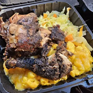 Half dark jerk chicken with steamed vegetables and mac &amp; cheese