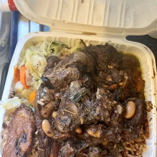 Oxtails Dinner with plantains and cabbage