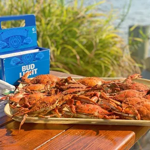 a tray of crabs on a picnic table