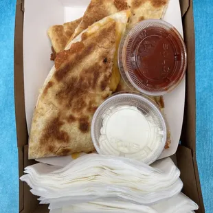 a box of quesadillas and condiments