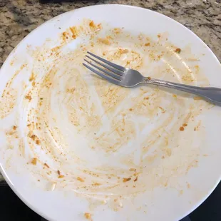 a dirty plate with a fork on it