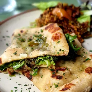 HAND-MADE FLATBREAD WITH PROSCIUTTO, MINT PESTO, STRACCHINO &amp; ARUGULA