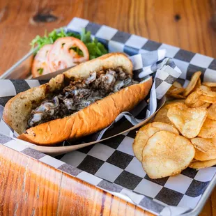 Sliced steak, griddled, topped w/ melted cheese, served on a toasted hoagie roll.