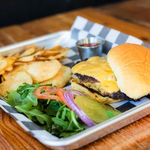 Two 1/4 lb patties smashed 'n seasoned, served w/ American cheese, toppings on the side