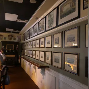 a wall full of framed photographs