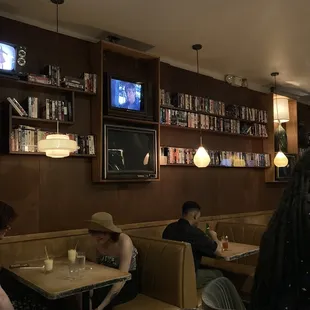 people sitting at tables in a restaurant