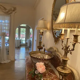 a hallway with a marble table and a mirror