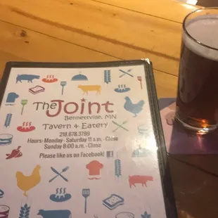 a menu and a glass of beer