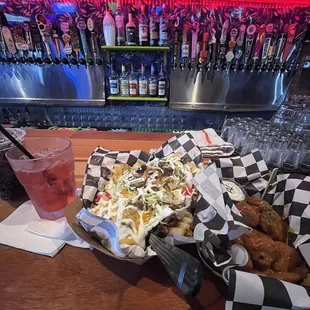 Nacho style loaded waffle fries, 10 boneless wings with gold rush bbq sauce. Chefs kiss