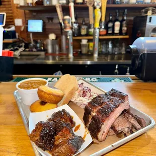 a tray of ribs and sides