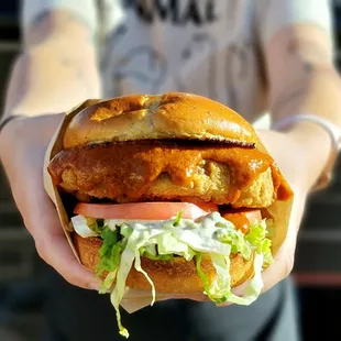 a person holding a sandwich