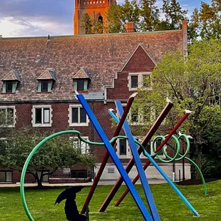a dog sitting in front of a sculpture