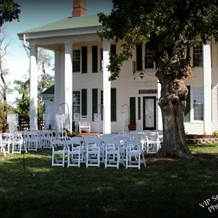 The front of the home used as a stage for a wedding ceremony.
