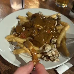 Irish chicken curry over fries because they ran out of fries