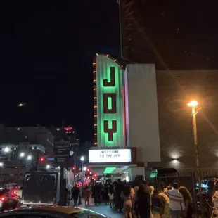 a crowd of people and cars