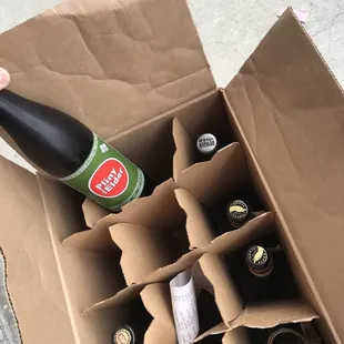 a bottle of beer in a cardboard box