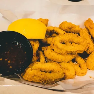 a basket of fried squids and dipping sauce