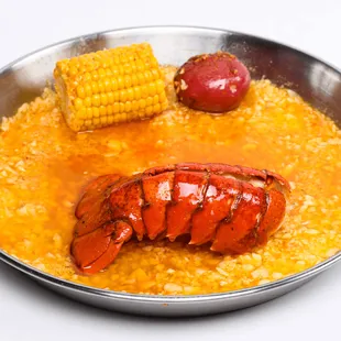 a cooked lobster and corn on the cob