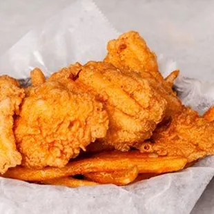 a basket of fried fish and fries
