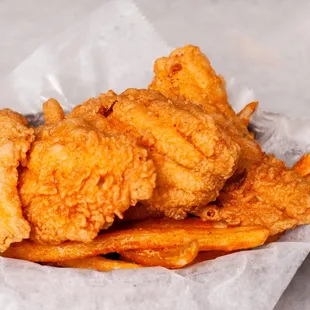 a basket of fried fish and fries