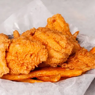 a basket of fried fish and fries