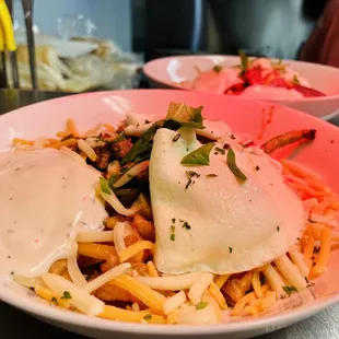 a bowl of pasta with a side of sauce