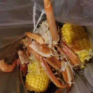 crab legs, corn, and corn on the cob