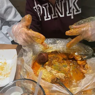 seafood boil including crab legs, potatoes, corn, and shrimp.