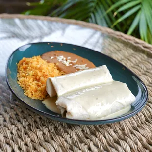 Don Panchos Burrito - two burritos stuffed with (your choice of meat), smothered in queso dip, and served with rice and beans.