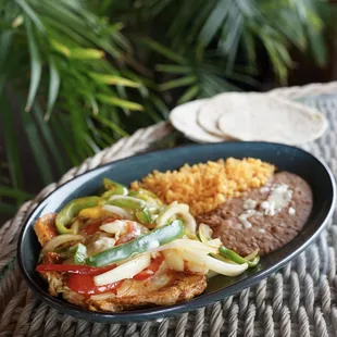 Chicki Blanco - grilled chicken filet covered with grilled onions, tomatoes, bell peppers &amp; queso dip, served with rice and beans