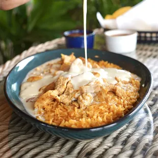 Arroz Con Pollo -  a bed of mexican rice topped with your (choice of meat) then covered with queso dip &amp; served with warm tortillas
